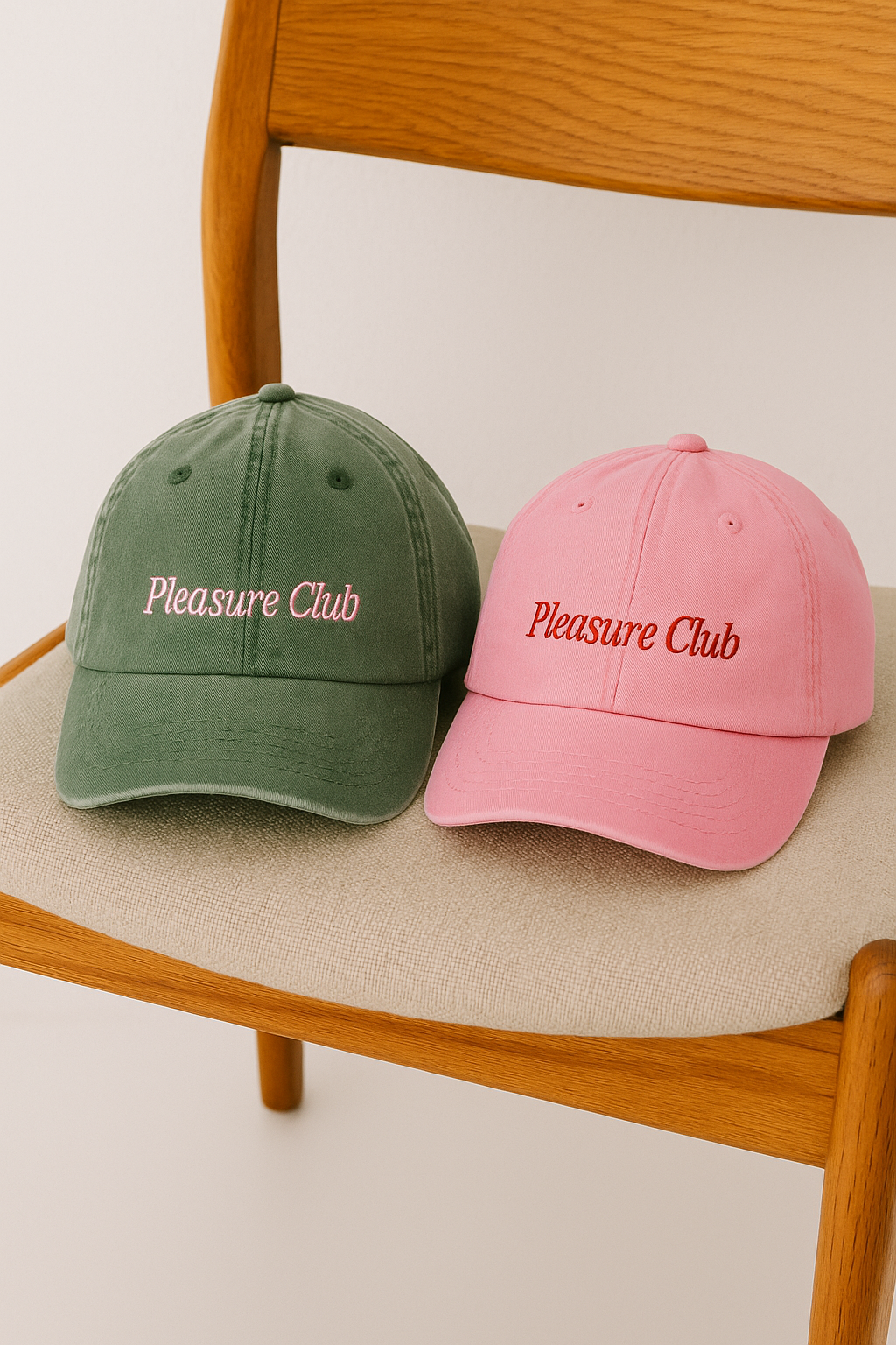 Green and pink Pleasure Club hats on chair
